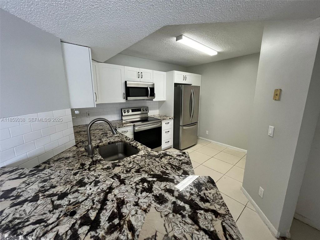 Photo of 8821 Wiles Rd #203, Coral Springs, FL 33067 (MLS # A11859338)