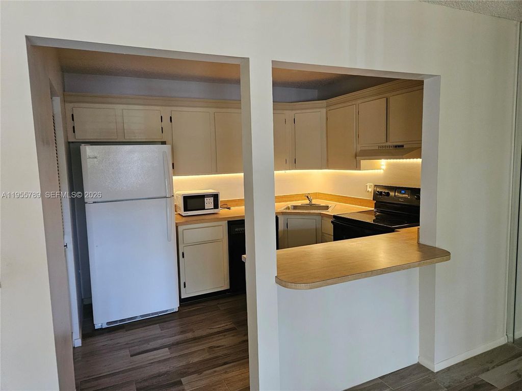 Photo of 441 SE Pine Glen Ln #A-2, Green Acres, FL 33463 (MLS # A11955789)