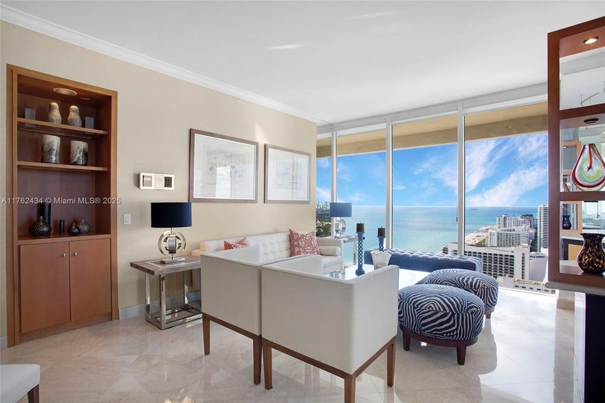 This stunning 2-bedroom, 2-bath corner unit is located on the 40th floor of a prestigious Miami Beach building. The southwest-facing unit boasts high ceilings throughout, creating an open and airy atmosphere. The beautiful marble flooring enhances the elegance of the space, while natural light pours through floor-to-ceiling windows, offering spectacular views of the Miami skyline, ocean, and bay. The spacious en-suite primary bedroom features a large bathroom and a walk-in closet. The wrap-around terrace is perfect for relaxing while taking in the breathtaking surroundings. Located in a prime Miami Beach area with excellent amenities, this unit is a true gem.