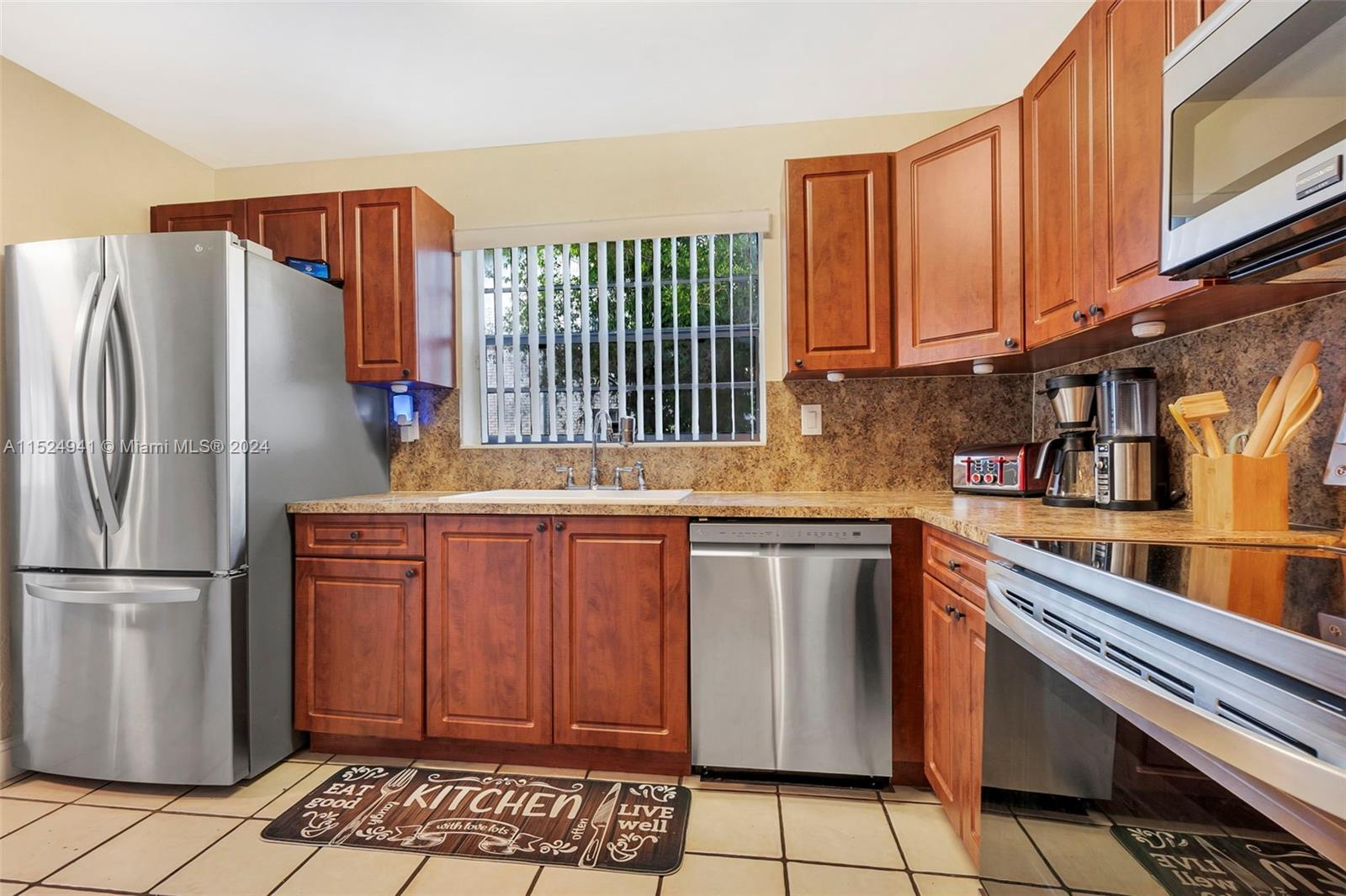 Rare opportunity! Explore this corner unit condo-townhouse located in the Springwood community of Coral Springs. With a large floor plan, this oversized unit offers three bedrooms and two and a half bathrooms. The kitchen provides wood cabinetry, sleek countertops and newer stainless steel appliances. Neutral tile flooring in the main living space and the added convenience of a first-floor laundry room. Tons of natural light. Step outside to the private paved patio and enjoy the convenience of open parking. Centrally located near major highways, shopping and dining establishments.