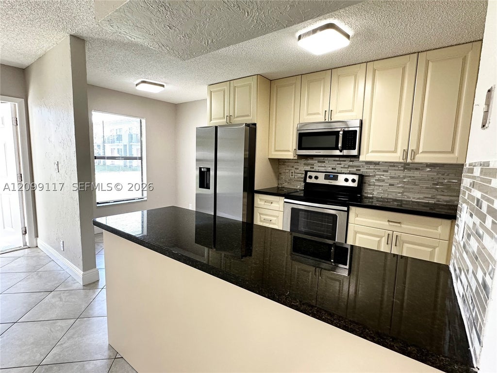 Photo of 5515 Courtyard Dr #5515, Margate, FL 33063 (MLS # A12099117)
