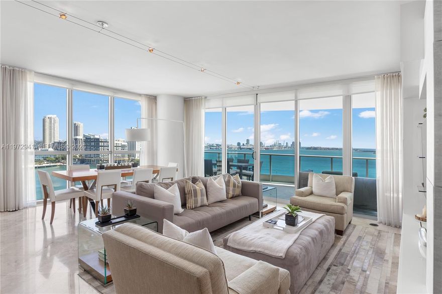 Welcome to Unit 1901 at Jade Residences at Brickell Bay, a NE corner residence in the Brickell Financial District with panoramic views of Biscayne Bay and the Atlantic Ocean. Bathed in natural light, this immaculate home features a private elevator entry and foyer opening to expansive living areas framed by floor-to-ceiling glass. Marble floors throughout, designer wallpaper, custom wood paneling, and electric shades. Oversized covered terrace ideal for sunrise views and entertaining, offering seamless indoor-outdoor living with breathtaking water views from multiple rooms. Includes 2 assigned parking spaces and private storage. Furniture negotiable. Full-service waterfront building in a premier bayfront location near Brickell dining and shopping.
