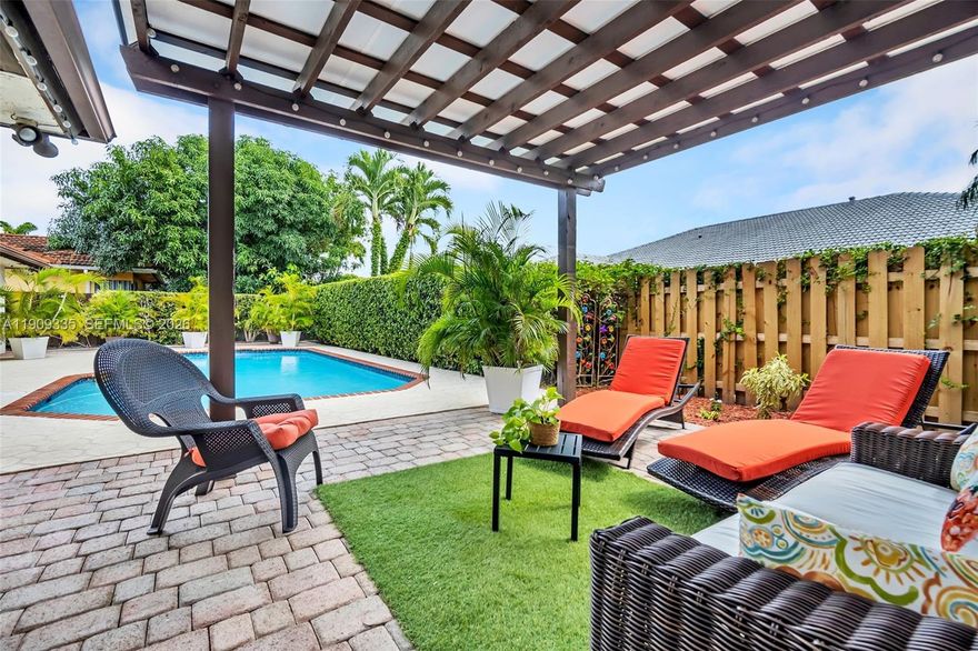 Exquisite Single-family residence with no HOA, ideally situated in the heart of The Hammocks. This impeccably maintained home offers an open-concept flow, impact windows, and elegant tile and porcelain flooring throughout, and a home security cameras system for peace of mind. The kitchen and bathrooms have been tastefully remodeled with wood cabinetry and high-end appliances. The garage has been converted into an office room, featuring a window and storage, and can be easily converted back to a garage if desired. Enjoy a lush backyard retreat with pergola, paver patio, and ample room for entertaining. The circular driveway has been freshly resurfaced and painted. All sitting on a double foundation. Ideally located near parks, lakes, and shopping.