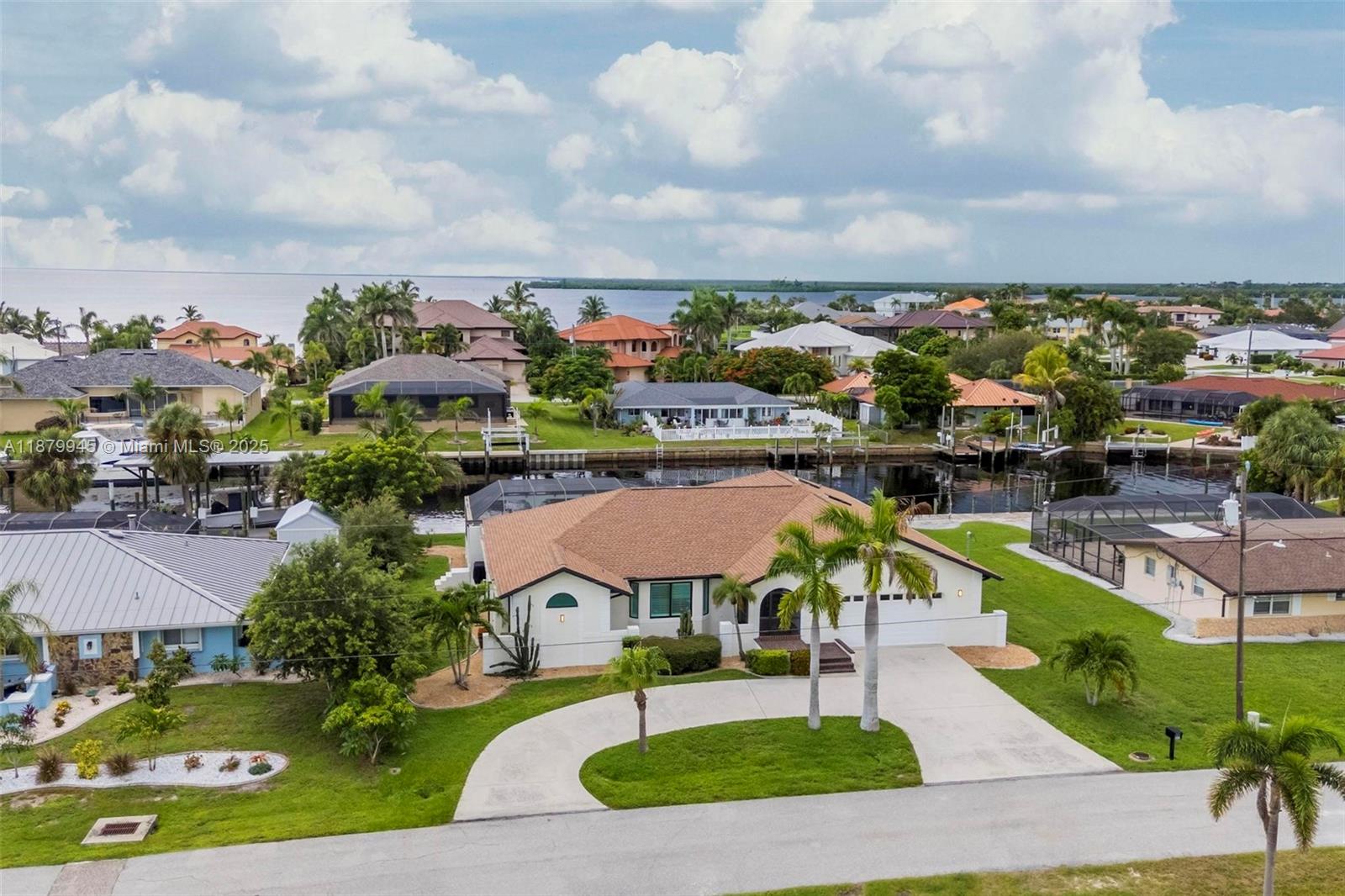 Experience the best in waterfront living from this high & dry residence. Major marine upgrades under contract & set for completion by Winter 2026. A new engineered vinyl seawall w/ reinforced 30-inch concrete cap will replace the existing structure, ensuring long-term protection & value. A 60-foot composite dock & 20,000 lb all-aluminum boat lift w/ remote control & stainless direct-drive motors offer effortless access to open water. All permits approved & work awarded to Florida Marine Work. The home itself features a 2023 roof, new ACs, impact windows/doors, remodeled interior w/ luxury flooring, chef’s kitchen & updated baths. Resort-style pool area w/ marble deck & shower completes this exceptional property delivering peace of mind, premium functionality & lasting waterfront appeal.