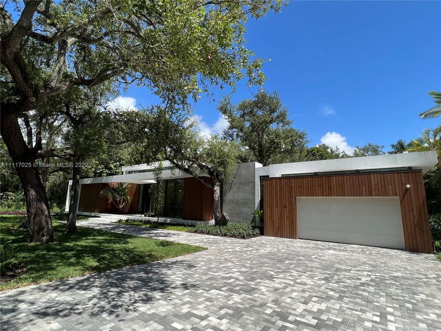 The Oaks, a one of a kind contemporary home located in the heart of Pinecrest, sits on a 29,620 SqFt private flag shaped lot nestled within an oasis of matured Oak Trees. This luxurious smart home, a custom design by award winner SDH studios, is situated close to Coral Gables and walking distance to Gulliver Prep and other Pinecrest schools.  Featuring an impressive great room with double height ceilings, interior garden which showcases a mature Oak Tree, gym, custom Italian cabinetry throughout, and a specially designed Binova Chef’s kitchen & Miele appliances. Master suite has an oversized boutique style closet, spa style bathroom and private terrace that overlooks the 48 ft pool. This 7bed/7.5bath home has 6416 sq ft under A/C. Estimated completion date is May 2022.