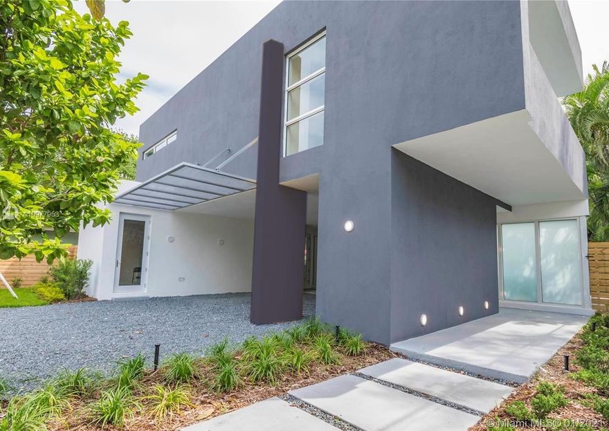NEW construction, DESIGNED by Mateu Architecture, this SMART home with GREEN features boasts an open floor plan with open kitchen overlooking the heated pool. OWNER FINANCING available! Upstairs balcony overlooks pool area and is perfect for sunbathing too. Storm protection such as high impact windows and doors and generator hook up make this one-of-a-kind home a peaceful security bunker during any storm! Unique home has an open floor plan with open kitchen featuring Italian cabinetry and state-of-the-art technology. First floor features a spacious bedroom suite that can also be used a media room or office. Oversized master suite upstairs sits elevated & secluded from the other upstairs suites. Private fence with electrical gate.