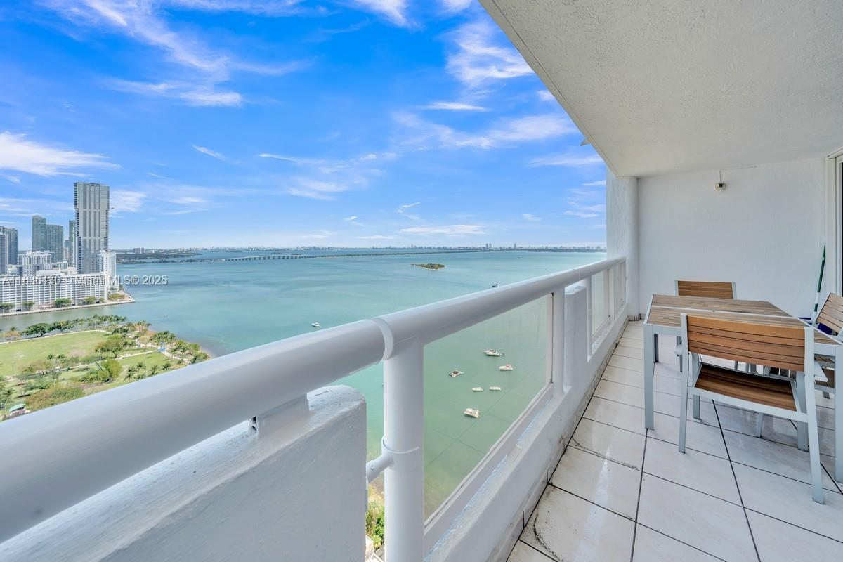Breathtaking bay and ocean views from huge balcony of this giant 1Bedroom 1.5 Bath Condo 1048 soft in the Double Tree Hilton/The Grand Condominium. Building features a large pool and 4 hot tubs/jacuzzis on 10th Floor and 24-hr fitness center. Tile floors throughout the home with a large bathroom with both a shower and bathtub. Oversized walk-in closet like another small room's worth of space. Modern washer and dryer in the unit. Kitchen features granite countertops and white cabinetry. Balcony access from both the living room and the bedroom with extra deep balcony to easily have a full outdoor dining table and lounge area over-looking Margaret Pace Park and the bay and ocean views. Spectacular home to make your own.