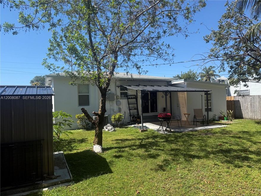 Welcome to this updated charming home in desirable East Hollywood a - PRIME LOCATION with NO HOA - This 2bed/1bath home is situated on a large fenced lot of 6770 sq ft with direct access from both sides of the street. from the main street and the back alley. The spacious and well-maintained back yard has beautiful mature trees, fruit trees and provides endless possibilities for creating your dream outdoor retreat with plenty of room for a pool or you can benefit from desirable zoning, offering excellent potential for additional rental income. This residence offers a bright open layout with abundant natural light and tasteful updates throughout. Move-in ready located near vibrant downtown Hollywood, beaches, parks, shopping, and major highways for easy access to everything South Florida has to offer. This property is ideal for investors or buyers seeking both comfort and opportunity. Impact windows a big plus!!