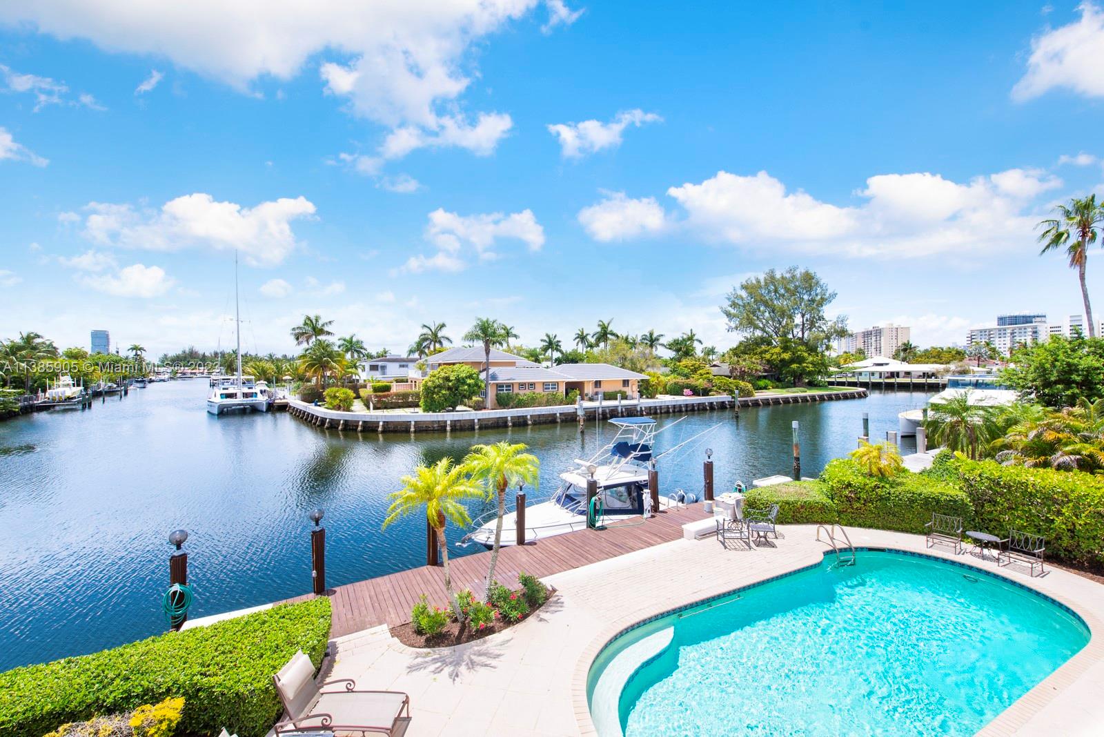 Hard to find 78' on a deep water ready to accommodate a large vessel, just a 30 min cruise to the open ocean. You will love living in Golden Isles where yachters and sea lovers share the common passion of a South Florida lifestyle as well as security, convenient shopping and the sand at their fingertips. Inside the home you will witness a large expanse of windows inviting an amazing pool, ocean breezes, amazing sunsets, and water-view looking down the "T" of the wide water. This beautifully maintained executive style home has an open spacious floor plan, high ceilings and wonderful architectural detail. A large primary bedroom and bath on the main level. His and hers closets, atrium shower and jetted tub. Two bedrooms upstairs and plenty of room to expand.