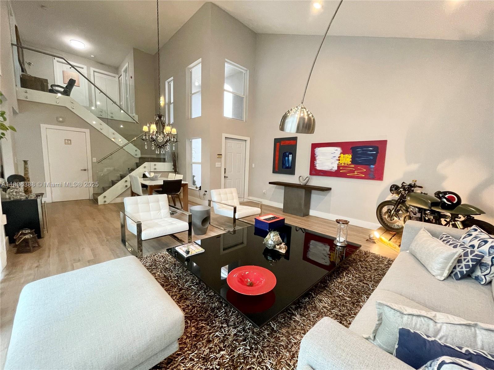 Stunning SFH at the sought after West Lake Village. Open floor plan and double high ceiling, tastefully remodeled including PGT impact windows, wood-like porcelain floors, new kitchen with solid wood, soft closing cabinets and quartz countertops, Samsung appliances, new bathrooms with floating vanities, rain shower and separate floating tub, beautiful glass stair railing, smart NEST thermostat, all LED lights. Good size paved patio and 2 car garage with 220v outlet for Electric car charger plus a 2 car driveway. WLV is a Resort like community with 24/7 security, guarded gates, a mile to the beach and amenities such as heated pool, jacuzzi, gym, basketball & tennis courts, kids playground. Close to supermarkets, shopping and fine dining.