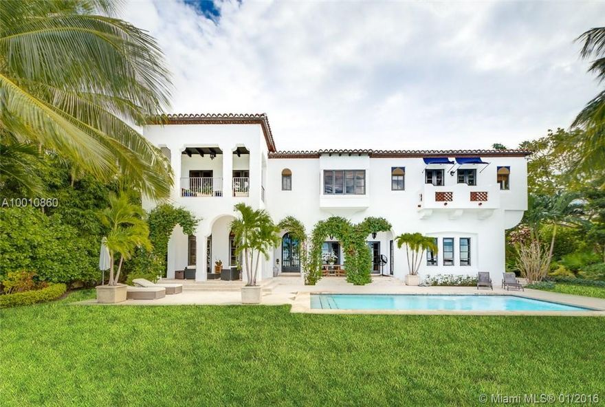 Moorish style estate built in 2004 w/ sweeping wide bay/skyline views. Custom wood & wrought iron door opens to interiors of stone & hardwood floors, stunning arched hallways complemented by natural light. Interiors: Spacious living room, formal dining room w/ custom wood ceilings & gourmet  kitchen w/ stainless steel appliances. Master suite w/ 2 walk in closets, guest house, balconies, French doors from evry room w/ access to multilevel courtyard & views 117’ of waterfront, pool & boat dock w/lift