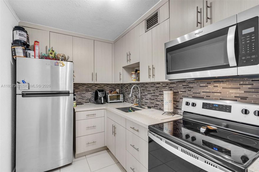 This charming first-floor unit in Summit Chase offers easy access with no need to wait for an elevator or climb stairs, making it safe and convenient for people with mobility challenges or elderly residents. Enjoy a spacious living room with a unique decorative rock wall and a screened-in patio perfect for relaxing. Note-worthy items include a large walk-in closet and stainless steel appliances. The community features 24-hour security, a pool, tennis courts, and a clubhouse with one assigned parking space, ample guest spots, and a prime location near SR836 and the Florida Turnpike and Clinics. This condo provides comfort and convenience. 40-year certification completed.
