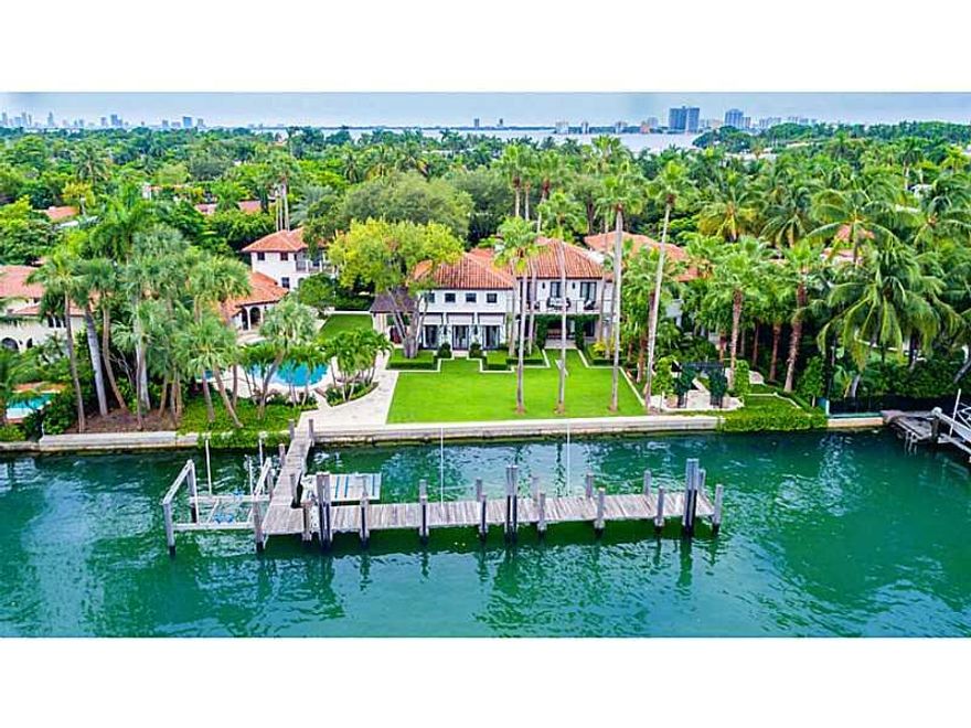 Experience the grandeur & elegance of this truly romantic Mediterranean estate located on prestigious Pine Tree Dr Circle. Home features 175' of direct waterfront overlooking scenic Indian Creek ideally situated on rare offered 1.1 acre lot. This meticulo usly remodeled & expanded 1937 estate features 2015 state-of-the-art technological integration & boasts 9BR/11+2BA, a 22,000 gallon pool, spa, koi pond, sculptured gardens,gym, wine cellar, library, safe room, 2 BD guest house, 2 guest apts, private dock.