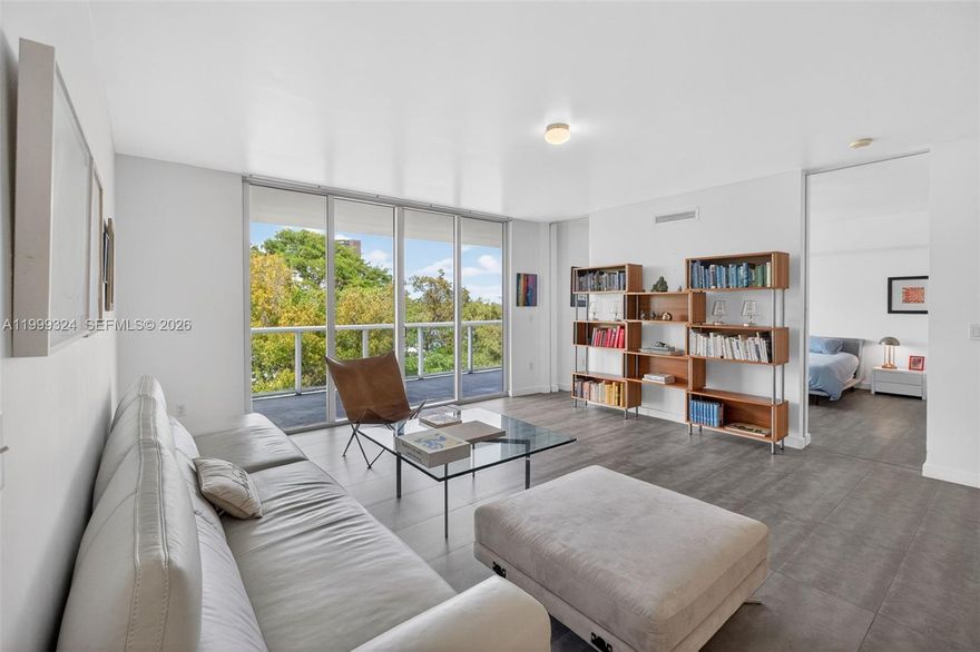 IOS on the Bay is a beautifully designed 5-story, 43-unit boutique condominium built in 2008. Situated on the 4th floor, this spacious and thoughtfully laid-out residence offers over 1500sf of indoor and outdoor living with lush treetop and bay views from every room. A standout feature is the expansive, deep balcony that spans the entire length of the unit. Covered by the building’s architectural overhang, it creates a true indoor-outdoor living experience, ideal for relaxing or entertaining year-round. Interior highlights include large-format tile flooring, high ceilings, floor-to-ceiling pocket doors, walk-in closets, and a large primary bathroom with a glass rain shower. The unit also includes a private storage locker and two parking spaces. The building features a bay front pool overlooking Biscayne Bay, a well-appointed resident gym, and on-site property management. Located east of Biscayne Blvd and directly on Biscayne Bay, IOS is nestled in Miami’s historic MiMo District, with direct access to the Morningside neighborhood and Morningside Park. Enjoy being just steps from a variety of restaurants, shops, the Farmers Market, and entertainment options.