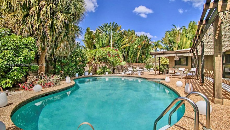 Escape to your own Private Resort in this stunning 4-bedroom, 3-bathroom home, complete with an oversized pool & expansive outdoor space perfect for entertaining. The open layout features a split floor plan with two primary suites, plus a convenient cabana bathroom for post-swim rinses. The kitchen offers ample storage, while the living room provides a comfortable place for relaxing. Situated on a huge corner lot, the outdoor entertainment area is a tropical paradise, filled with lush plants, trees, & vibrant flowers. Ideal for outdoor dinners & sunset cocktails or simply relaxing in the peaceful garden setting. Located just 5 minutes from the beach, close to shops, restaurants, cafes, and bars, this home offers the perfect for a relaxing vacation. Ask about rates & availability.