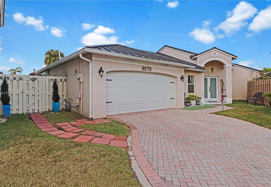 Nestled within the prestigious gated community of Lago Mar, this exceptional residence offers a perfect blend of modern upgrades and timeless architectural appeal. The home immediately impresses with a new metal roof, providing both striking curb appeal and long-term peace of mind. Inside, the interior is defined by elegant tile flooring throughout, seamlessly connecting the living spaces under soaring high ceilings that create an airy, expansive atmosphere. The thoughtfully designed split bedroom plan ensures maximum privacy for the primary suite, while the heart of the home features a beautifully updated kitchen and tastefully renovated baths. For ultimate protection and convenience, the property is equipped with an impact front door and roll-down shutters. Transitioning outside, the covered patio offers an ideal space for year-round entertaining and relaxation in the South Florida sun.