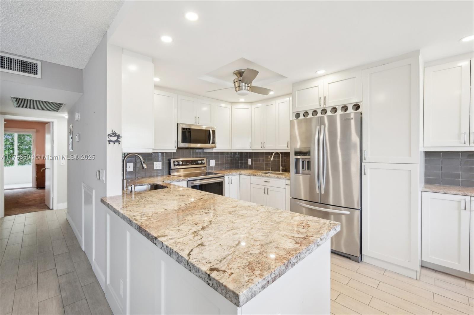 Fully Renovated gorgeous condo with water view. This stunning open concept unit has been completely updated with wood look tile floors, a brand-new kosher kitchen, modern bathrooms--new everything! Finished Florida Room with Hurricane Impact glass, Brand New A/C & Electrical Panel. Total of 1024 sq ft. Quartz Counters, built in closet systems, frameless shower & much more. Rexford C has No Assessments, Good Reserves, Certification is complete. Buses stop in front of condo and take you to the clubhouse and beyond. Residents enjoy Houses of Worship in the Comm., heated indoor/outdoor pools, Pickle ball, Tennis, Water Aerobics, Fitness center, classes and activities are offered. putting green, tiki hut, BBQ area 1,252-seat theater, billiards, card rooms. Resort-style living at its best!