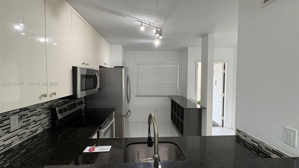 Photo of 9560 Weldon Cir #J308, Tamarac, FL 33321 (MLS # A12012497)