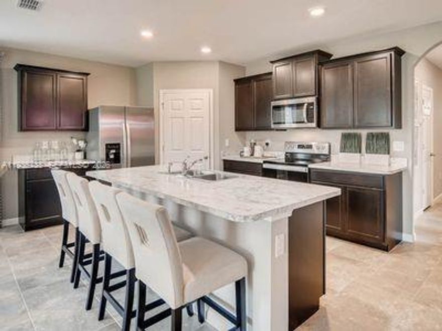 The Cali floor plan by Dr. Horton stands out as a popular choice for families seeking a spacious and functional living space. This 4/2 single-story layout offers a thoughtful blend of comfort, style, and functionality.
Spacious Open-Concept Living Area creates a welcoming and inviting space perfect for family gatherings, entertaining guests, or simply relaxing. The abundance of natural light from large windows enhances the sense of spaciousness and brightness. Gourmet Kitchen with a large Island with a breakfast bar, providing ample counter space for meal preparation and casual dining. The kitchen is equipped with stainless steel appliances, granite countertops, and a walk-in pantry, ensuring both style and functionality.
Luxurious Primary Suite, walk-in closet. Energy Efficiency and Smart Home Features, Great Outdoor Living Space. 
GGMV