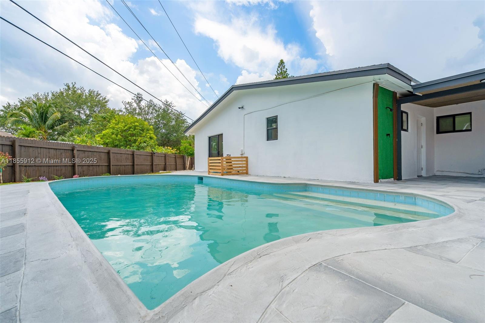 This fully upgraded 4BR/2BA single-family home features a spacious open layout, 2-car garage, modern kitchen and bathrooms, new roof (2025), impact windows and doors, and stylish flooring throughout. Enjoy a large pool, pergola for outdoor entertaining, and plenty of parking space—including room for an RV and over 8 cars in the driveway. Flooded with natural light and surrounded by upgraded landscaping front and back. Ready for immediate move-in. Easy to show