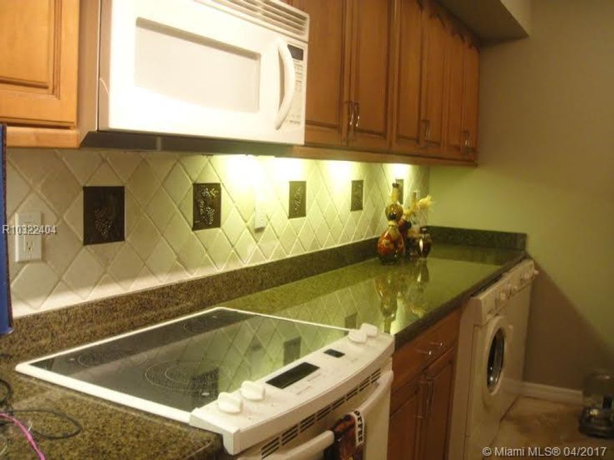 Beautiful sunsets grace this lake front, 14th tee box stunning view from the home.  Updated kitchen, granite countertops, custom hardwood cabinets with new refrigerator and under counter washer/dryer.  Updated, split, dual sink bathroom with hardwood cabinets and granite tops.  Beautiful ceramic tile throughout the home.  Living/dining area is spacious and adjoins to the scenery facing patio---making a perfect, open for entertaining.  Lots of closet space too in this spacious 1100 sq. foot country club con