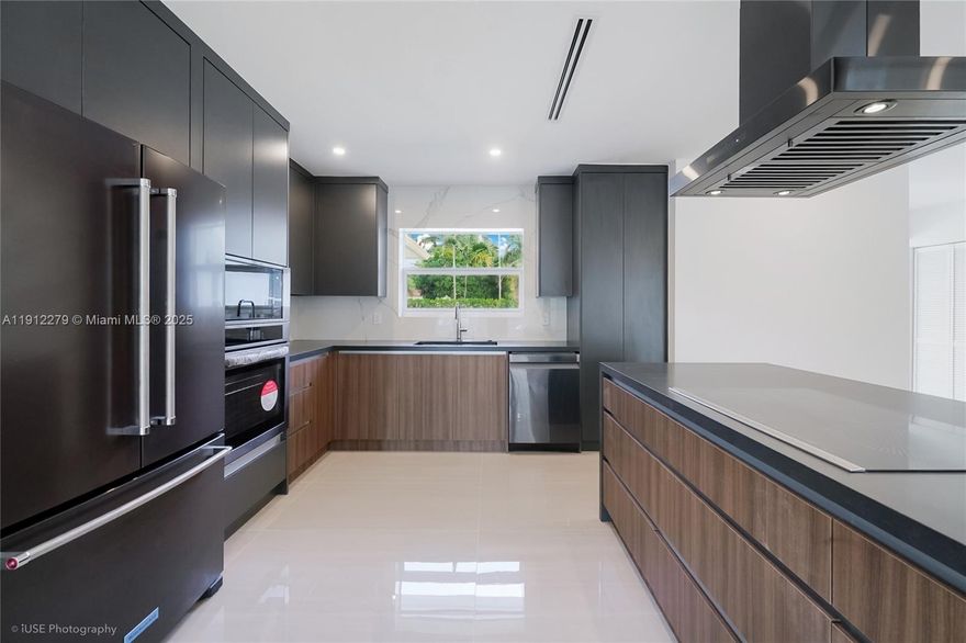 Modern luxury meets comfort in this beautifully remodeled 3-bedroom, 2.5-bath Miami Shores home. With 2,700 SF of living space on an oversized 12,000 SF lot, this residence offers style, privacy, and space in one of Miami’s most sought-after communities.
Natural light fills every corner, highlighting high-end finishes and thoughtful details throughout. The open-concept kitchen features natural stone surfaces, premium appliances, and custom cabinetry. 
Enjoy the best of Florida living outdoors with a new pool, hot tub, and spacious backyard. The large garage offers the option for parking, storage, or an easy conversion to a guest suite or studio. On a quiet dead-end street, this home is move-in ready with a brand-new HVAC system and all major updates completed