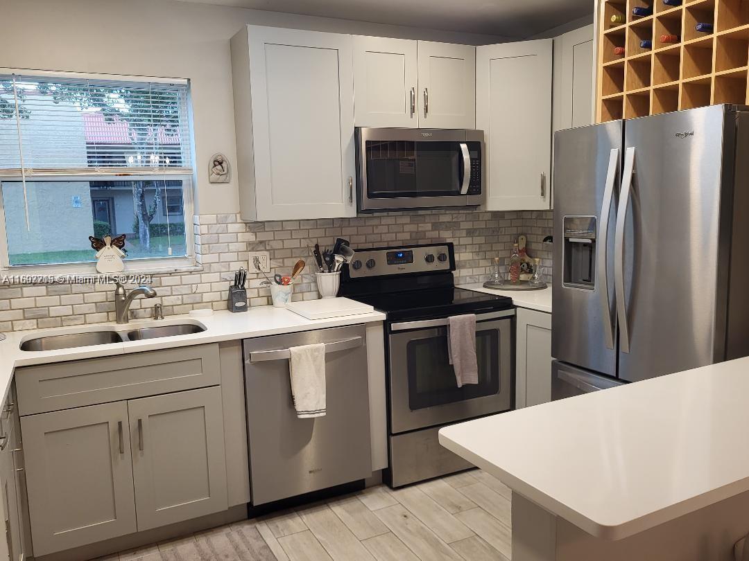 Newly fully furnished first floor condo in a 55+ community overlooking a wide canal, Olympic pool and clubhouse. New kitchen cabinets, quartz countertops, stainless appliances and flooring throughout the home. Beautifully furnished w/ small appliances, pots, pans, silverware, dishware and linens...just bring your toothbrush. The patio is enclosed with hurricane impact windows and doors leading onto a paved patio with furniture overlooking the water and garden. The master bedroom has 2 walk in closets. The second bedroom has its own en-suite with plenty of closet space. Assigned parking space is close to your front door and restaurants, beach and shopping are a short drive. World-class pool, spa and sauna are a short walk out back. The association approval is quick and easy so act fast!