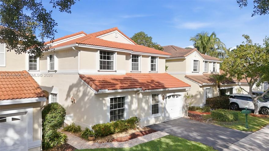 Welcome to Emerald Isle at Weston, where soaring ceilings, abundant natural light, and thoughtfully designed spaces create a warm and inviting atmosphere. This sought-after Arvida Topaz One model offers a spacious two-story layout with 4 bedrooms, 2.5 baths, generous living and dining areas, a family room, and a one-car garage. Dramatic volume ceilings and expansive windows fill the home with light, creating an open, airy feel throughout. The kitchen offers elegant countertops, stainless steel appliances, and a functional layout that connects comfortably with the home’s living spaces. Both full bathrooms have been beautifully updated, while the screened patio and private fenced backyard framed by tropical greenery create a peaceful outdoor setting for relaxing or entertaining. Perfectly positioned directly across from Tequesta Trace Park, the location offers immediate access to scenic walking paths, open green spaces, lighted athletic fields for soccer, football, and lacrosse, four baseball/softball fields, a roller hockey rink, skate park, and nearby recreation facilities including pickleball. Nearby schools (walking distance) and everyday conveniences are just moments away at Weston Lakes Plaza, with additional shopping, dining, and entertainment nearby at Weston Town Center, enhancing the convenience and appeal of this exceptional Weston location.