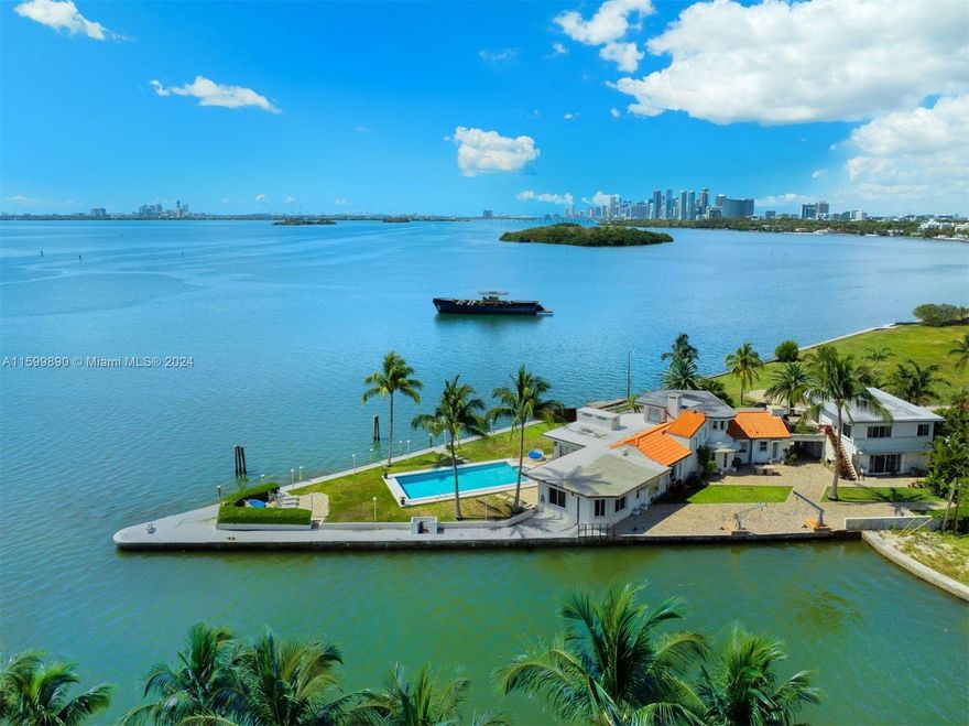 This rarely seen amazing waterfront property sitting at a point impressively surrounded by approximately 350 ft of water on Biscayne Bay is just waiting to become a “Dream Home”. It is truly a unique and hidden gem nestled in a quiet and private dead-end street. This expansive 20,470 sq ft lot is in a prime location in the trendy MiMo/Upper-Eastside district and conveniently located to Miami Beach, Airport, and all Sports and Entertainment Venues. A Boater’s paradise with endless open Bay Views offering a perfect blend of urban convenience and a private “Resort Life-Style”! Don’t miss the chance to create your perfect oasis in this sought-after location.