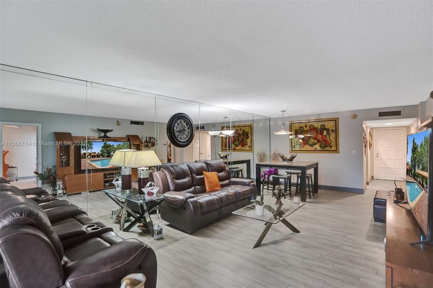 Price adjustment. Beautiful move -in ready 2 Bedroom/2 bathroom unit with direct views of the pool area, lush garden, and golf course. Property features two guarded entrances with 24hr surveillance. Enjoy walk/jog/bike rides alongside the trail. The unit is located on the fourth floor with elevator and stair access. Unit features new plank tile, an upgraded kitchen with brand new stainless steel Samsung appliance, brand new a/c, renovated bathrooms, and a large patio. Bedrooms have large walk-in closets. Each floor has washer, dryer, and storage room. Community offers pool maintenance, beautiful landscaping, 24 hour security, and pest control. HOA includes internet, water, cable, trash and sewer.  All ages are welcomed.