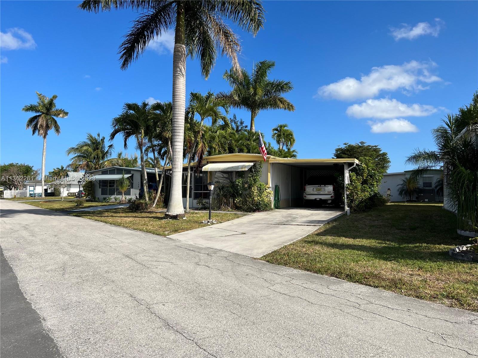 Great 55+ community in Boynton Beach, FL, surrounded by golf courses. LOW HOA because you own shares of the land, this is a CO OP. HOA includes basic cable & internet, sewer, water, trash pickup, lawn paint and maintenance of community. Large Clubhouse with spacious conference room, game room with pool table, shuffle board, pool, and different social activities to stay entertained including a gold league. Enclosed porch and laundry room/workshop behind the carport. Cash only, AS IS sale. All measurements are approximate. Easy to show. Priced $34,000 below next highest comparable property in community. Sale includes new washer/dryer, 55 inch TV, Kuerig Coffee Machine and blender.