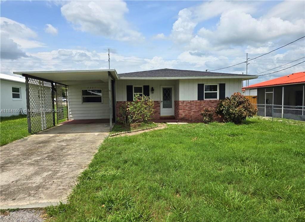 This home features a brand new shingle roof and a spacious room that can be used as a family room or a third bedroom, offering flexible living options. It includes two bedrooms and two bathrooms, along with a convenient 1-car carport. While the home is move-in ready, it does need some cosmetic updates, allowing you to personalize and make it your own. Located in a non-HOA community just off Sebring Parkway, it’s a great place to settle in.