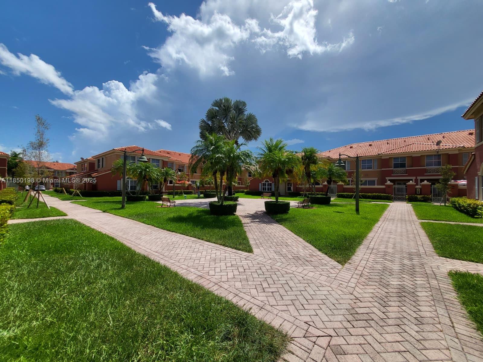 Welcome to your new home in the heart of Doral! This stunning townhome boasts 2 beds, 2.5 baths with private gate and charming oversized front porch with pavers—perfect for outdoor living. IMPACT WINDOWS tile & laminate wood floors, modern kitchen with SS appliances, granite countertops & snack bar, washer & dryer. NEW A/C! 2-car maximum (1 assigned and the non-exclusive right to use a guest space as your second parking spot). The association does not allow a 3rd car. The community features a sparkling pool and a kids' playground. Located within walking distance to Eugenia B Thomas Elementary School, this gated community offers security and peace of mind. This pet-friendly community. Don't miss out on this incredible opportunity to live in one of Doral's most sought-after neighborhoods.