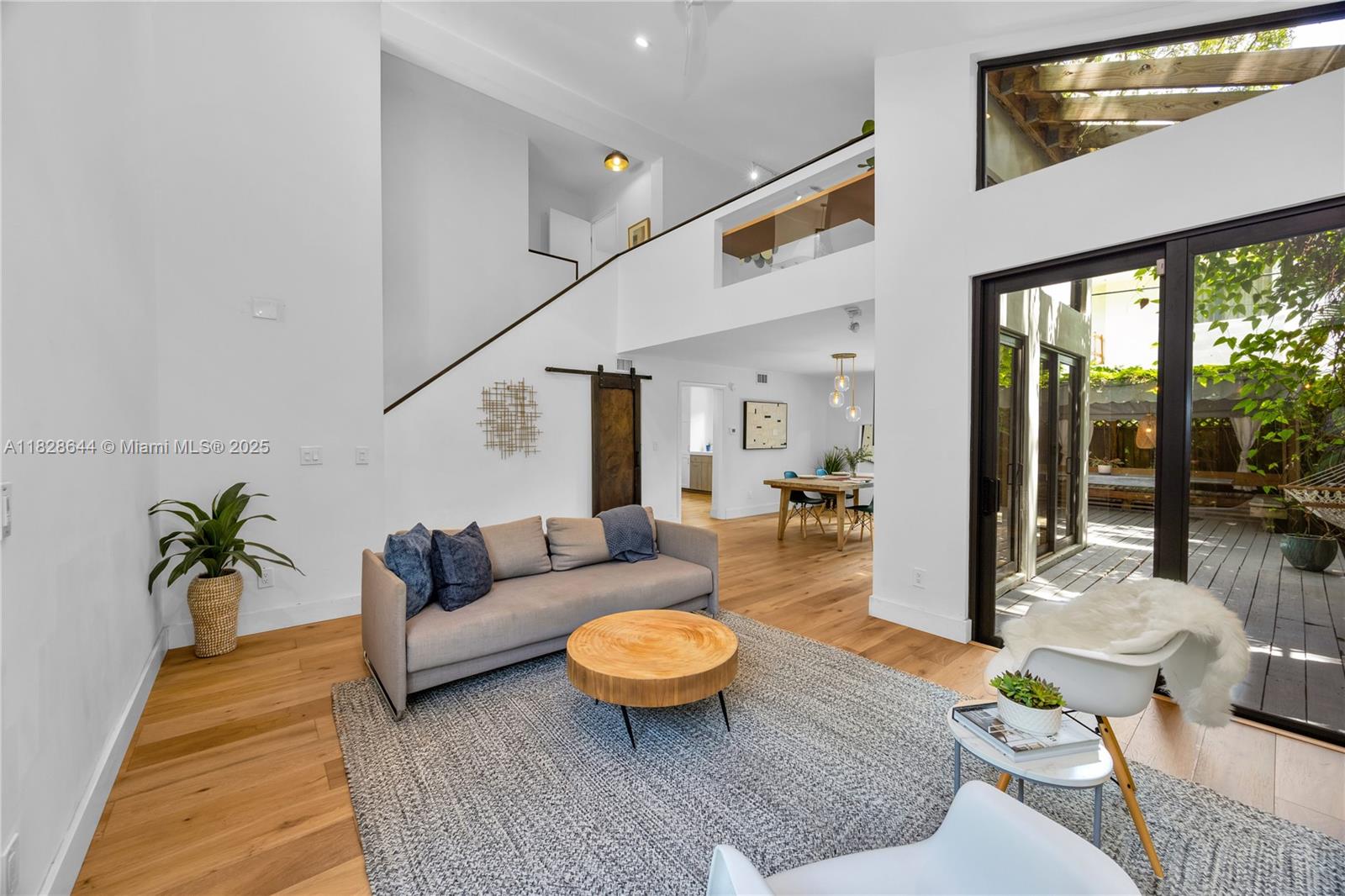 Groovy & Grove-y, this beautifully-updated 3 BR, 2.5 BA home sits in the middle of everything, just a stone’s throw from the Grove village center & downtown Miami! At 1,543 SF, the thoughtfully-designed home has spacious liv & din rms w/ sliding doors that step out to the charming patio w/ lovely dining area that seats a crowd! The updated kitchen includes quartz counters, stainless steel appliances, & large windows overlooking the garden that allow in abundant light. There is1 BR with a beautifully renovated en-suite BA downstairs, 2 add’l BR upstairs share an updated BA w/ double sinks, + there is a fabulous loft area that serves as the perfect office or hangout space. With a laundry room, impact glass, & wide-plank flooring, this house is a marvelous opportunity in the heart of it all!