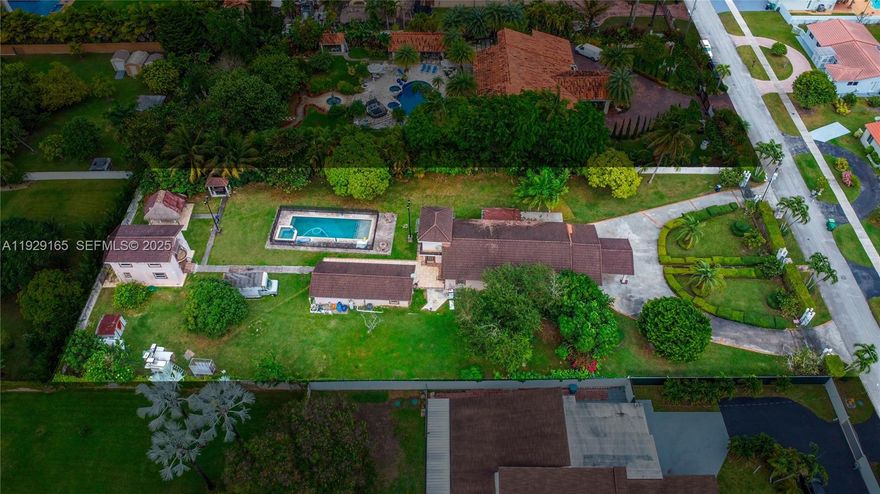 Rare opportunity in West Miami! This expansive property sits on an oversized 0.85-acre lot (±37,060 SF) just a few blocks from Belen Jesuit Preparatory School. Offering exceptional space, privacy, and versatility, this estate is ideal for end-users seeking a multigenerational layout, investors, or developers looking to capitalize on a unique parcel in a highly desirable location. The main residence features 4 bedrooms and 2 bathrooms, providing a comfortable and functional layout. In addition, the property includes two guest houses: • Guest House 1: 2 bedrooms, 1 bathroom — perfect for extended family or rental income. • Guest House 2: A two-story structure with 1 bedroom and 1 bathroom — an excellent option for an office, studio, or private suite. The massive lot allows room for further customization such as luxury outdoor living, pool, gardens, or additional structures (subject to county approval). A large driveway and carport offer abundant parking for multiple vehicles, RVs, or boats, all without HOA restrictions. Located minutes from major highways, shopping, dining, and top-rated schools, this property provides the rare combination of acreage, location, and multiple living quarters in the heart of Miami. Endless potential for multigenerational living, rental income, or redevelopment. A true one-of-a-kind opportunity.