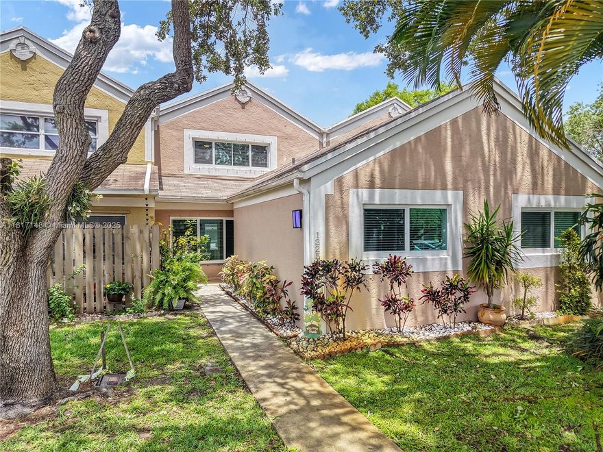 This stunning 3-bed, 3-bath townhome in Flamingo Villas offers modern upgrades in a gated community. The renovated kitchen boasts stainless steel appliances, granite countertops, a waterfall island, and 42” cabinetry. The spacious first floor features a living/dining area, bedroom, bath, and upgraded laundry room with quartz counters and custom cabinets. Upstairs, the primary suite has vaulted ceilings, built-ins, and recessed lighting. The back patio includes newer tile, a gazebo, and storage. Smart home features like keyless entry, a newer roof, impact windows, flooring, A/C, and tankless water heater. This low-HOA home is centrally located near top medical services and major highways.