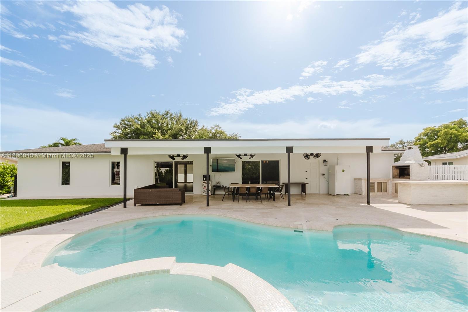 This beautifully remodeled Miami-Dade home offers a perfect blend of style, comfort, and practicality. The open floor plan is filled with natural light and features a chef’s kitchen with stunning wood cabinets, a walk-in pantry, wine cooler, and a hybrid 48” stove. The cozy master suite includes a walk-in closet and a designer bathroom for ultimate relaxation. Outdoors, enjoy a large backyard with a remodeled, heated pool and a custom BBQ area, perfect for entertaining. The oversized two-car garage provides ample storage space. This home delivers exceptional value with high-end upgrades and a prime location. Don't miss your chance—schedule a tour today and experience this stunning property firsthand!
