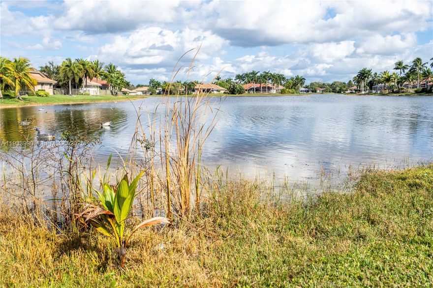 This BEAUTIFULLY REMODELED 5 Bedrooms and 3 1/2 Bathroom home has a 2 Car Garage and a pool! It is located on a pie shaped lot with LONG LAKE VIEWS  in the sought after community of  Weston Hills Country Club. This home features solid mahogany entry doors, beautiful modern kitchen with wood cabinets, large pantry, quartz counter tops and BOSCH stainless steel appliances, large marble master bath, walk in closets, crown molding throughout, hurricane shutters and much more. The open concept, high ceilings and  Triple split floor plan gives you all the space you need. A Rated Schools!