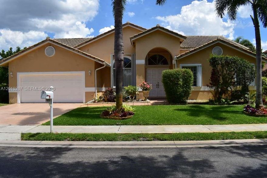 Oversized, fruit-laden, lot over 1/4 acre! Three (3) large bedrooms with 2.5 bathrooms. All bedrooms including the Primary Suite (Master) is on the ground floor. 12-foot ceilings in primary and living areas. Tiled in common areas, laminate in formal, and carpet in bedrooms. The 2-car garage and driveway provide ample parking. No neighbors in front - just open park to lake view, no neighbors behind. Expansive layout. Among the largest models in The Landings! Lake in front and with a covered screened porch for you to entertain your friends and family, or to simply relax. Established neighborhood with very low HOA fees at just $100 per month. Primary (Master Suite) has two closets, split double sinks, a tub, and an updated shower. Laundry room under air. Competitively priced for Pembroke Pines - show and sell.