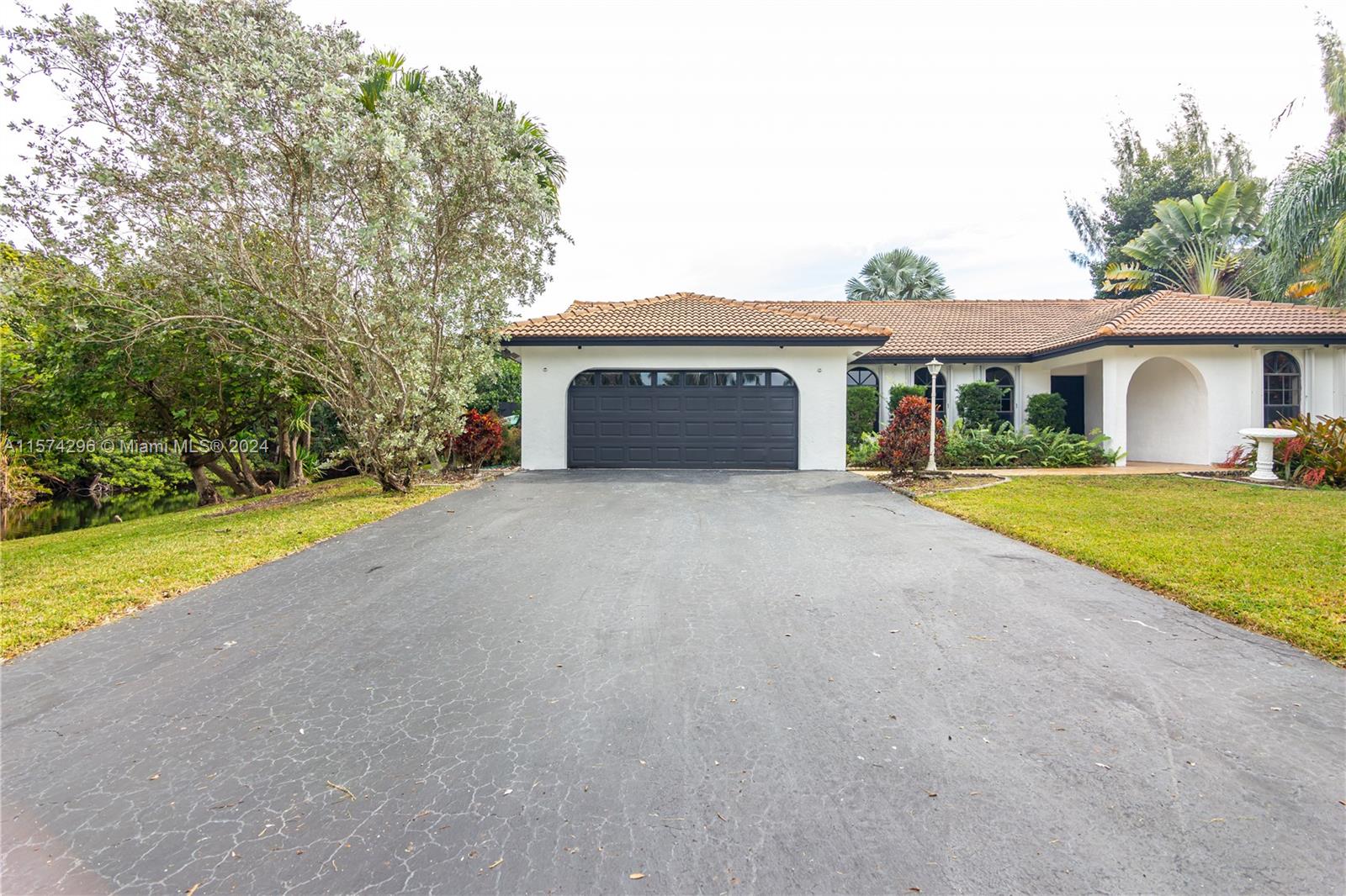 Opportunity to own your piece of paradise in the heart of sought after Martha Farms subdivision in Davie, FL.
Bright and spacious with tons of natural lights and surrounded by two lakes with almost and acre lot. Relax with your very own tropical landscape. This home features high ceilings, screened pool, accordion shutters, new floors, renovated kitchen and bathrooms and the list goes on. Converted garage with full bathroom and separate entrance for guests and in-laws. Tranquil neighborhood with high rated schools. No HOA!