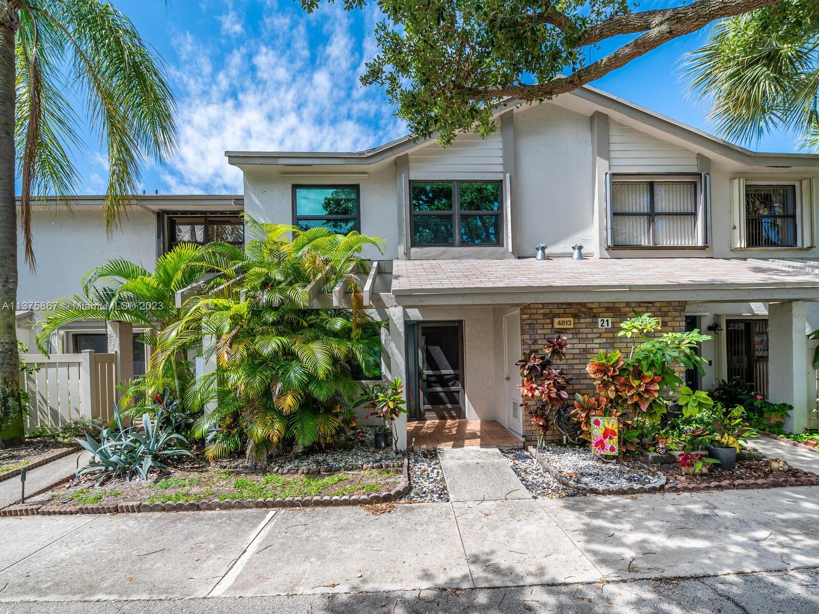 This beautiful townhome features 3 bedroom, 2.5 bathrooms and is located in a cul de sac location and also a lake front lot! This completely remodeled home features a dream kitchen with 2 wall ovens, cooktop with microwave above, wood cabinetry with granite, stainless appliances. All bedrooms on 2nd level. Wood look porcelain tile throughout entire home. Master bathroom has a jacuzzi tub. All closets are built out. Hurricane protected with IMPACT WINDOWS AND DOORS! Storage unit closet on the exterior. Custom painted interior and some areas have wallpaper. Walk up the tiled steps to this beautiful wall has marble, stone with artificial grass. The community pool is walking distance from the unit BUT enjoy all the amenities at The Township Center