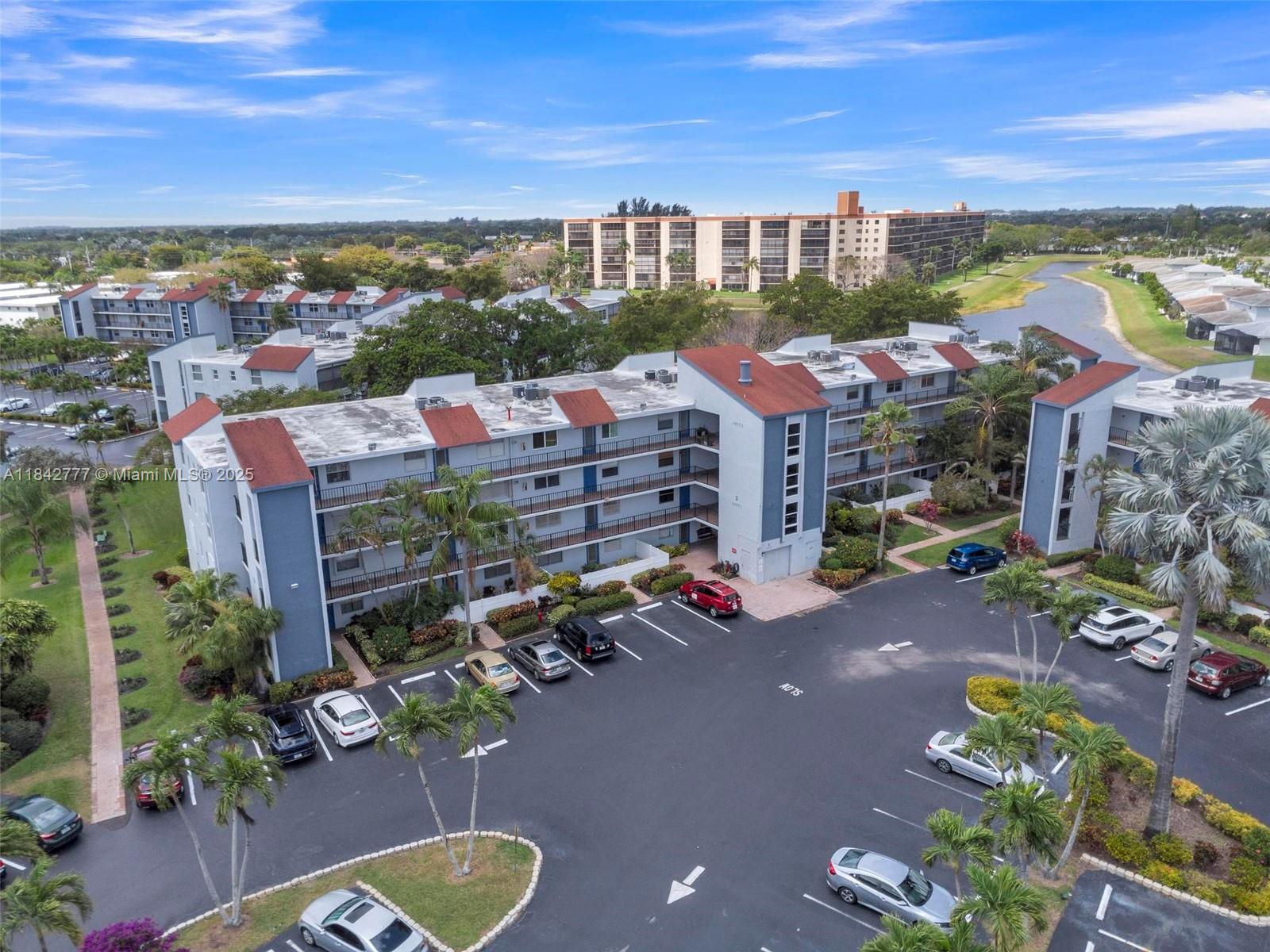 Must See Corner Unit with amazing views 2 Bed/ 2 Bath Condo with Stunning Water and garden views from the screened patio, living room and primary bedroom. Welcome to the coveted 55+ community of Deauville Village in West Delray Beach. This spacious and meticulously maintained condo is a beauty and has been upgraded with new flooring, kitchen and bathroom upgrades and much more. The HOA includes Water, Sewer, Trash, & Xfinity Cable TV. Brand-new State of the Art Clubhouse, Pool, Spa, gym, and Recreation facility.