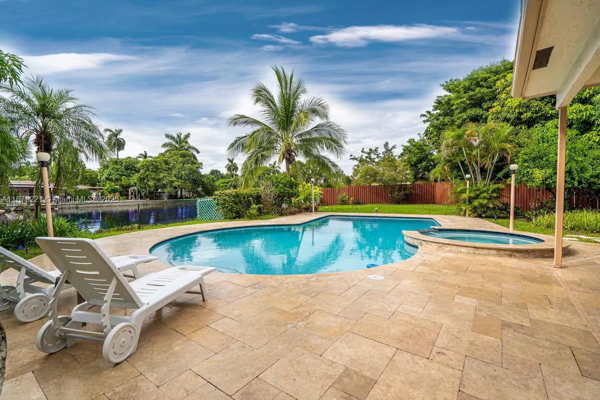 Featuring a private dock, one-car garage, pool, and lush tropical landscaping, this fully furnished 3-bedroom, 2-bath waterfront home in Hollywood offers the ultimate South Florida lifestyle. Situated at the end of a quiet cul-de-sac and surrounded by water on three sides, the property provides serene views and direct canal access to the Intracoastal Waterway. Inside, the home boasts an open layout with modern appliances, tasteful furnishings, and plenty of space for everyday living or entertaining. Accommodations include a master suite with king bed, a guest room with queen, a guest room with two twin XL beds, and a sleeper sofa in the living area. Conveniently located just minutes from Hollywood’s beaches, shopping and dining, this residence combines comfort, privacy, and prime location.