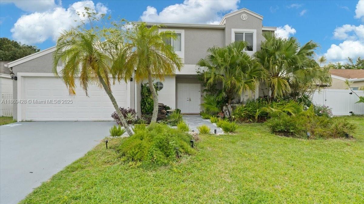 This recently updated single-family home offers 3 bedroom, 2.5 bathrooms, and a spacious office that can be converted into a fourth bedroom. The home features new impact hurricane windows and doors, and a 2-car garage with extra driveway parking. A huge balcony is also connected to a new outdoor kitchen, with a workstation sink, a coal barbecue with a rotisserie grill system, and a bar. Fire pit area, large west-facing completely fenced-in. This private backyard includes mature trees and fruit trees around the entire property. The backyard also includes a charming pergola, waterfall fountain, and one more covered space. Located in Boca Landings.
