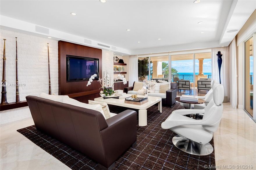 This 3BR/3+1BA Oceanside corner unit features 3,691 SF of immaculately designed interior spaces w/Crema Marfil marble floors, Venetian plaster walls & large ocean side wraparound terrace w/unobstructed sunrise beach & Atlantic Ocean views. Spacious open living room w/a beautiful onyx bar & dining room surrounded by walls of glass that stream natural lighting. An amazing gourmet kitchen sports top of the line Miele & Sub-Zero appliances, custom Snaidero cabinetry & a large breakfast area. The sumptuous principal suite offers an office space, direct terrace access & stunning principal bath w/limestone floors, walk-in rain shower & sunken spa tub. The other two bedrooms each with en-suite bathrooms & share a terrace w/Fisher Island views. 5-star Fisher amenities complete this offering.