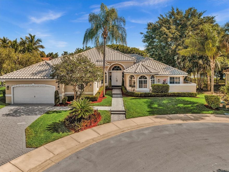 Beautiful One-Story Home with Panoramic Lake Views in Weston Hills! Located on a private & quiet cul-de-sac, this stunning home sits on one of the most premier ½-acre pie-shaped waterfront lots in the community. Features 5BR/5BA + Office (possible 6th BR), soaring 14’ ceilings, and custom impact windows & doors showcasing spectacular lake views. The open and inviting floor plan provides the perfect canvas to personalize and elevate this home to your taste. Spacious kitchen with center island, gas cooktop, 42” cabinets & desk area. Roof replaced Oct. 2011, 3 zoned A/C units, and 80-gallon water heater. Enjoy South Florida outdoor living with a large covered & screened patio and pool area—perfect for entertaining and relaxing with serene lake views.