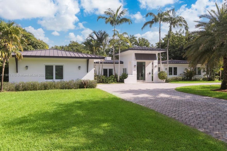 Gorgeous and fully updated Pinecrest family home situated on a picturesque 31,700 sqft corner lot in southeast Pinecrest.  House was totally reconstructed (taken down to cinder blocks and roof taken off and raised!) and added on to in 2014: metal roof, PGT impact glass windows and french doors, PVC plumbing, electrical, 3 ACs, salt-water pool, outdoor kitchen, elevated ceiling height, rectalinear marble floors, central vac and more!  3/2 on one side of the house including the stunning bed and breakfast feeling primary, and 1/1.5 plus an office on the other side.  Spacious indoor laundry room, 2-car garage w/EV charging station, 2025 sprinkler system and new alarm/security system, tons of light, and just an overall wonderful and easy flow house.