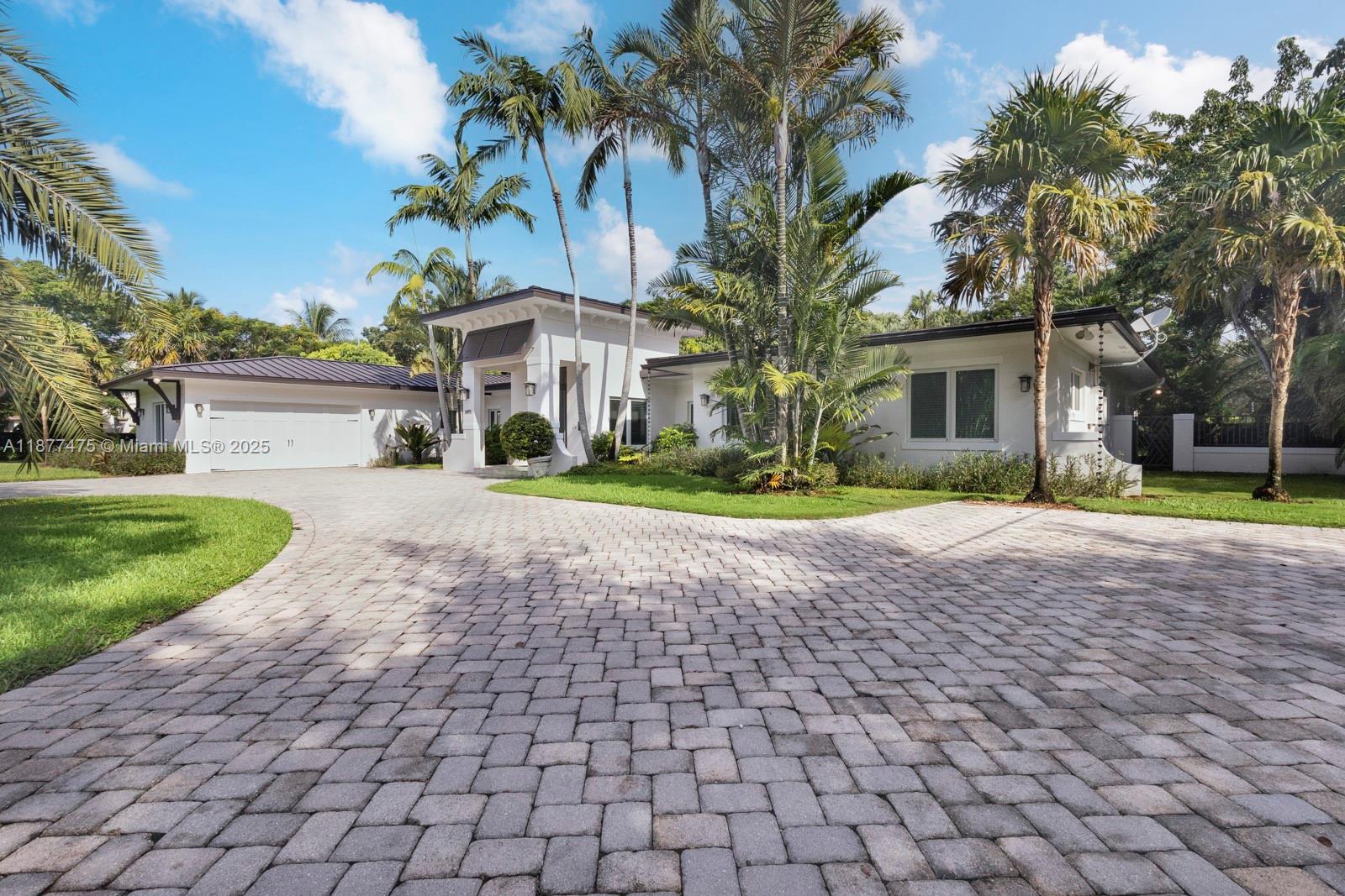 Gorgeous and fully updated Pinecrest family home situated on a picturesque 31,700 sqft corner lot in southeast Pinecrest. House was totally reconstructed (taken down to cinder blocks and roof taken off and raised!) and added on to in 2014: metal roof, PGT impact glass windows and french doors, PVC plumbing, electrical, 3 ACs, salt-water pool, outdoor kitchen, elevated ceiling height, rectalinear marble floors, central vac and more! 3/2 on one side of the house including the stunning bed and breakfast feeling primary, and 1/1.5 plus an office on the other side. Spacious indoor laundry room, 2-car garage w/EV charging station, 2025 sprinkler system and new alarm/security system, tons of light, and just an overall wonderful and easy flow house.