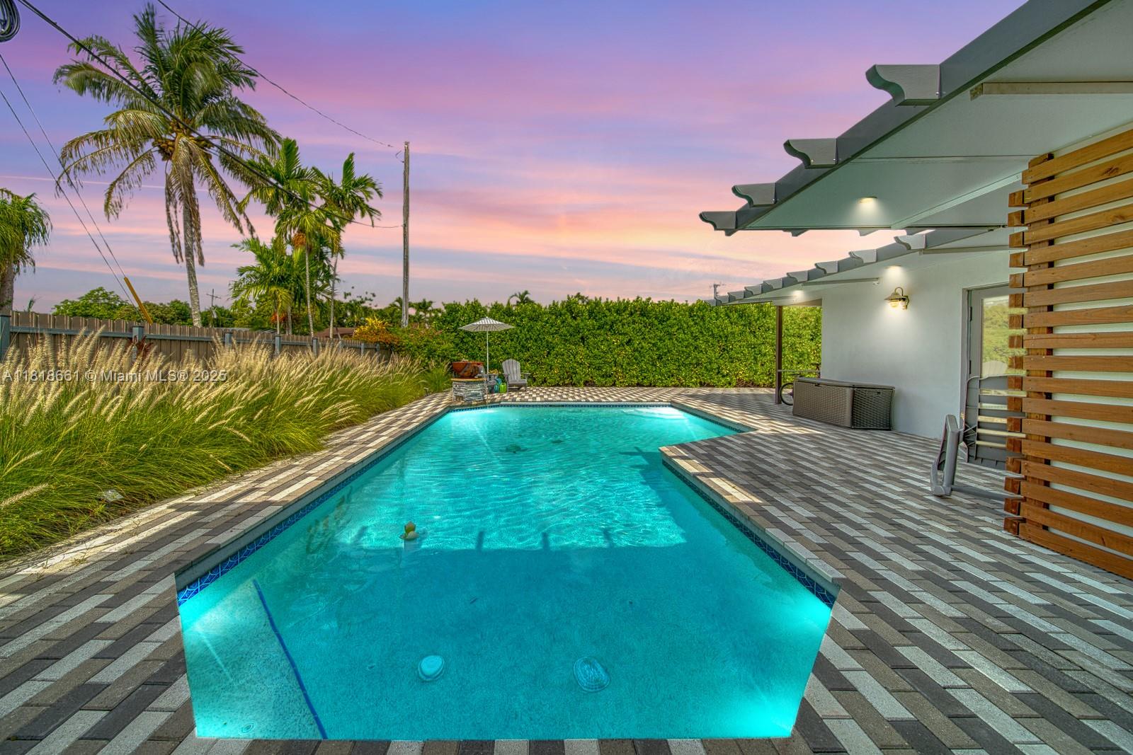 Experience refined Miami, Florida living in this elegant 3-bedroom, 2-bathroom pool home, centrally situated on a corner lot in coveted Westwood Estates. Priced to sell, this residence blends comfort and sophistication, offering an inviting circular driveway with ample space for a boat or RV. Inside, enjoy expansive light-filled living areas and a spacious primary suite with walk-in closets and tranquil pool views. Recent upgrades include impact windows and doors, plus a new interior HVAC unit (2024). Designed for seamless indoor-outdoor living, the backyard is a private oasis, featuring a resort-style pool with fireplace waterfall, ambient lighting, and a fully fenced yard—perfect for quiet evenings under the stars or lively gatherings. Virtual tour available upon request.
