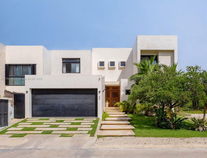 Mayan Puerto Aventura 15 min from TULUM is a modern yet cozy retreat in the serene coastal community Set along the marina, this villa offers breathtaking views from sunrise to sunset, making it the perfect escape for those seeking laid-back elegance. This amazing five bedrooms home has —three on the second floor and two on the ground floor. One of the ground-floor rooms, a tented living space by the pool. The spacious master opens to a private balcony with panoramic views and features an outdoor shower for the ultimate in relaxation and privacy. open-plan living and dining spaces seamlessly extend into the garden and infinity pool, blending with the marina’s scenic backdrop. Designed with sleek local chukum style and tropical wood accents, the villa exudes a cool, relaxed vibe.